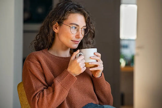 woman enjoying a warm beverage in the morning